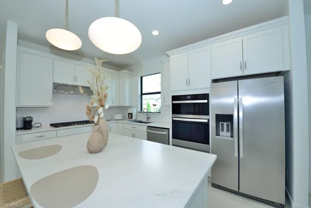 a kitchen with a refrigerator sink and stove