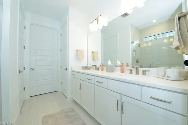 a bathroom with a granite countertop sink mirror and double