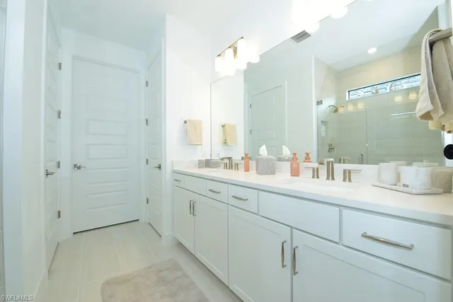 a bathroom with a granite countertop sink mirror and double