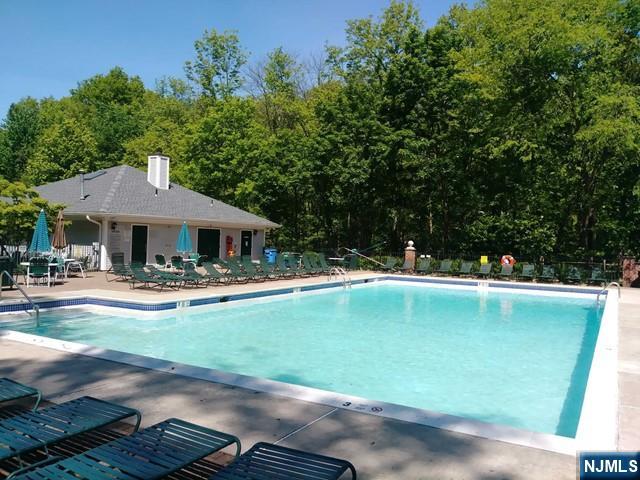 143 Raintree Lane Mahwah, NJ 07430 - Photo 19 of 19 a front view of a house with swimming pool having outdoor seating