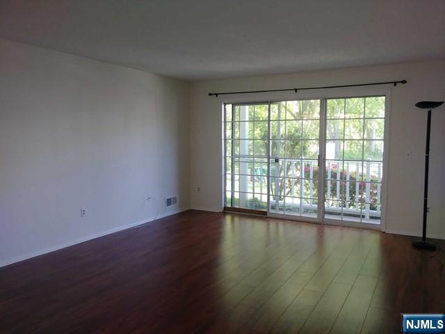 143 Raintree Lane Mahwah, NJ 07430 - Photo 2 of 19 a view of an empty room with wooden floor and a window