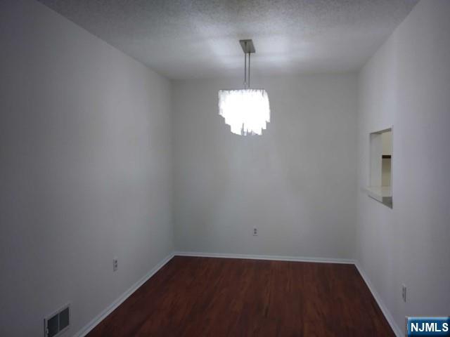 143 Raintree Lane Mahwah, NJ 07430 - Photo 3 of 19 an empty room with wooden floor mirror and window
