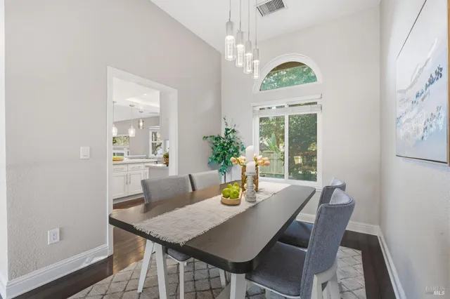 a kitchen with a table chairs stove and microwave
