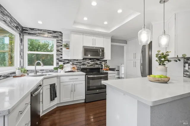 a kitchen with a sink a stove and cabinets