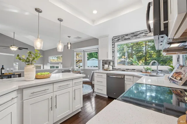 a kitchen with stainless steel appliances a stove sink and microwave