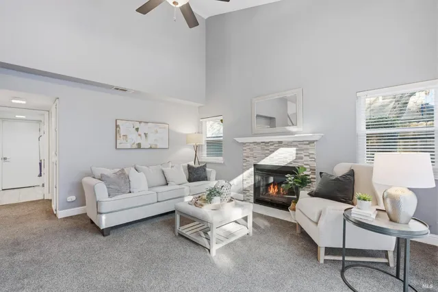 a living room with furniture and a floor to ceiling window