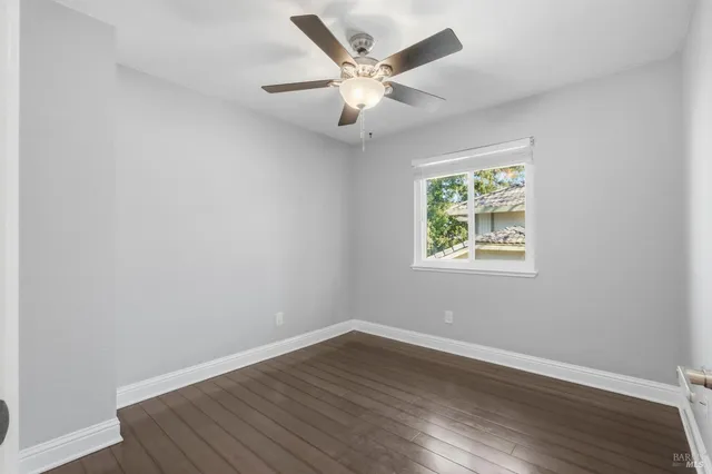 a spacious bedroom with a bed a chandelier and a window