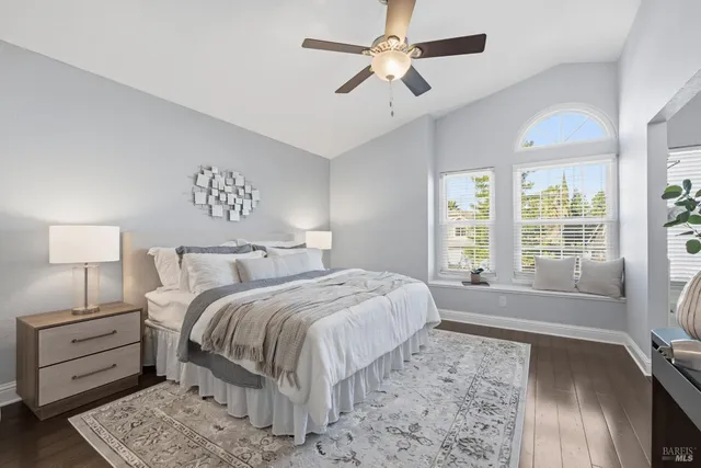 a spacious bedroom with a large bed and a chandelier