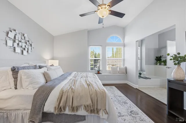 a spacious bedroom with a bed and a chandelier