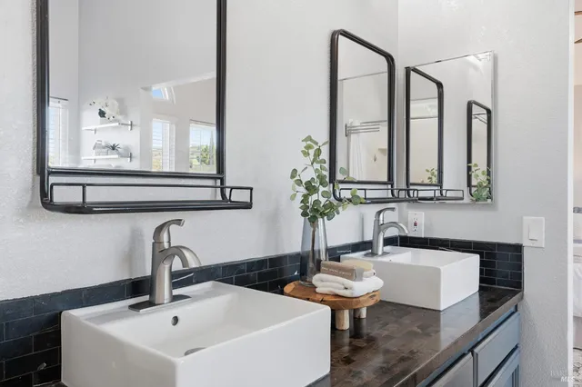 a bathroom with a double vanity sink mirror and