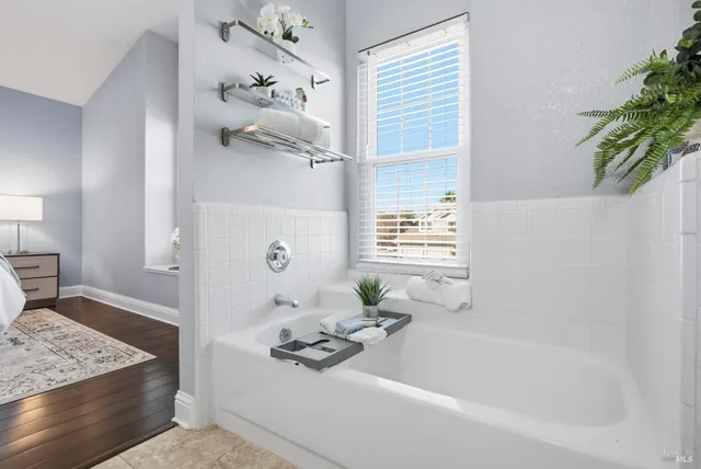 a bathroom with a bathtub shower and a sink