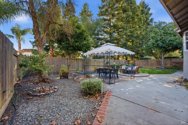 a view of an outdoor space with furniture and umbrella