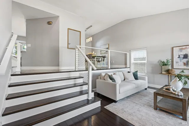 a living room with furniture and a potted plant
