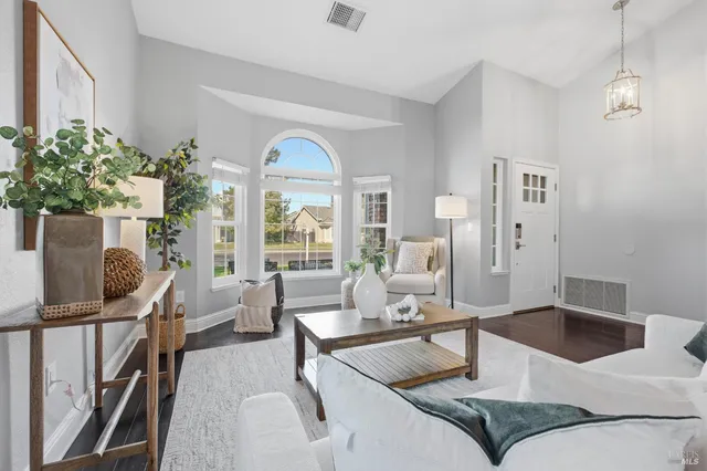 a living room with furniture and flowers