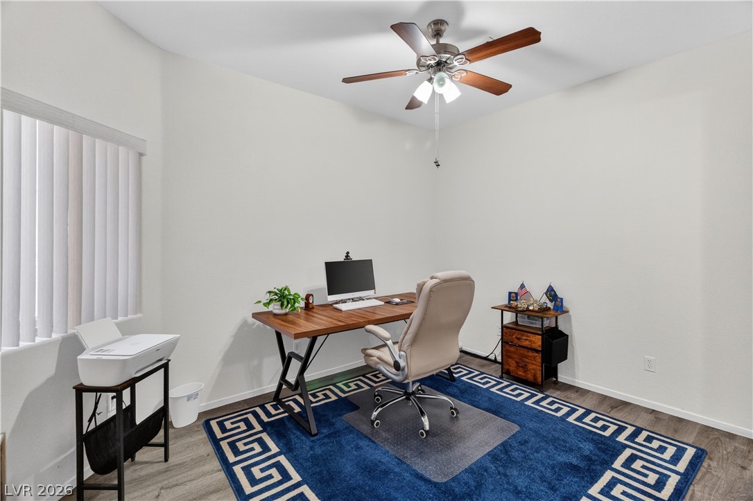 3376 Partridge Run Street Laughlin, NV 89029 - Photo 39 of 92 A quiet work-from-home haven features clean walls, a ceiling fan, and durable wood flooring.