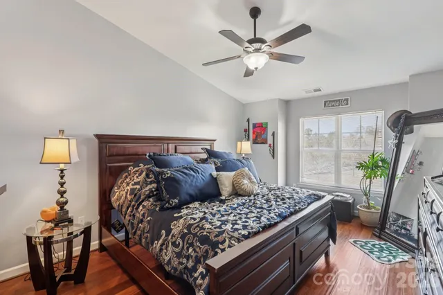 a bed room with a bed and a chandelier