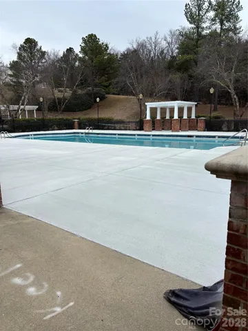 a view of swimming pool with trees in background