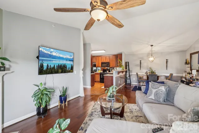 a living room with furniture dining room and wooden floor
