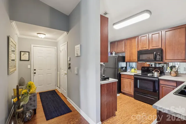 a kitchen with stainless steel appliances granite countertop a refrigerator and a stove top oven