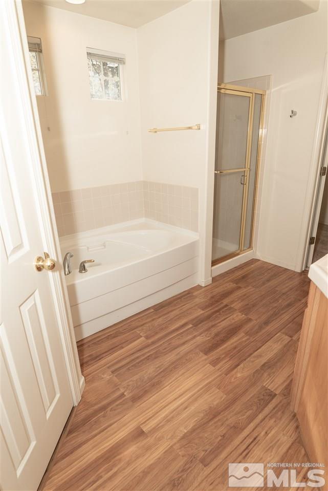 9693 Otter Way Reno, NV 89521 - Photo 13 of 21 a bathroom with a bathtub and a shower