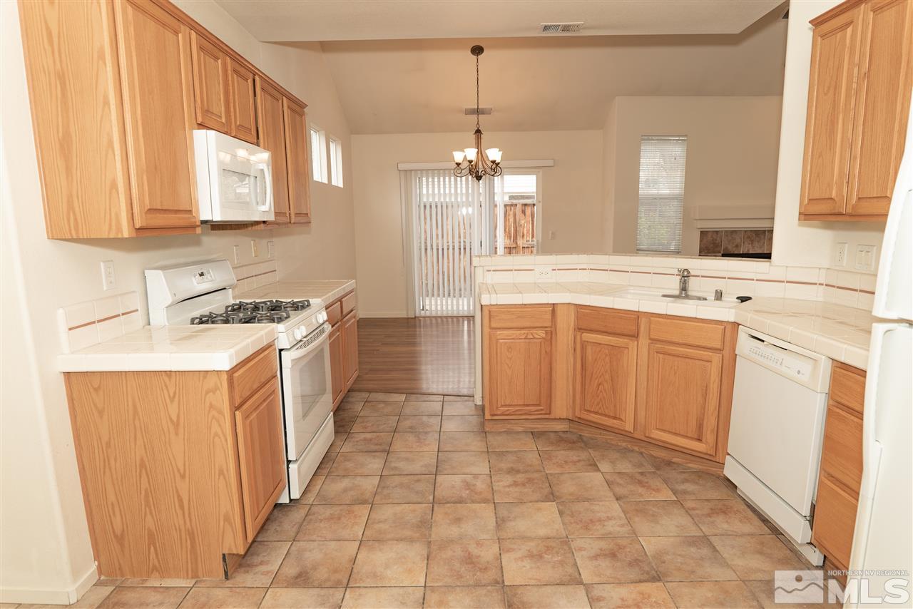 9693 Otter Way Reno, NV 89521 - Photo 8 of 21 a kitchen with a sink stove and cabinets