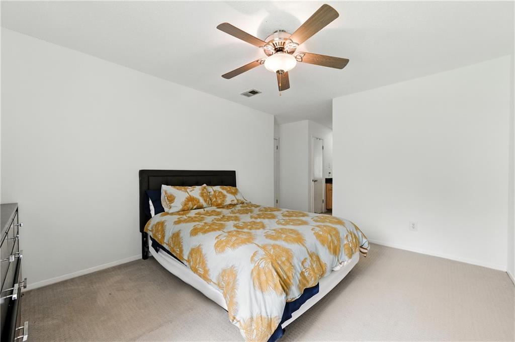 3301 Henderson Mill Road, Unit AA3 Atlanta, GA 30341 - Photo 23 of 32 a bedroom with a bed and a ceiling fan