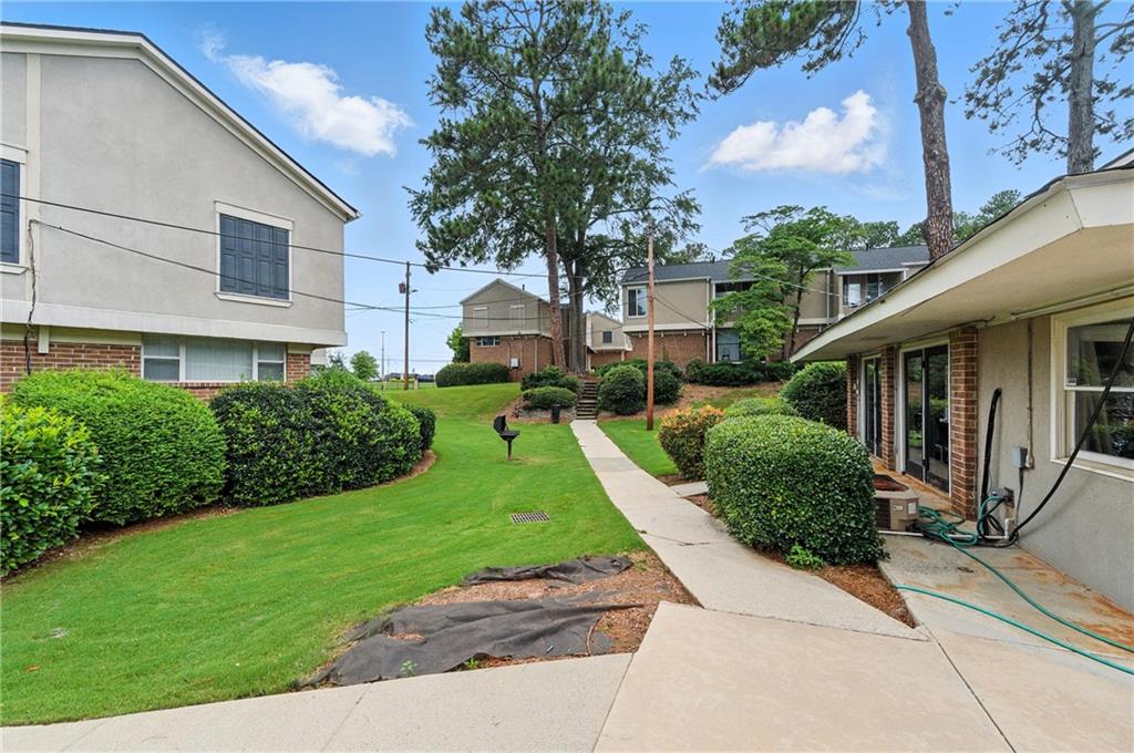 3301 Henderson Mill Road, Unit AA3 Atlanta, GA 30341 - Photo 30 of 32 a front view of a house with a yard