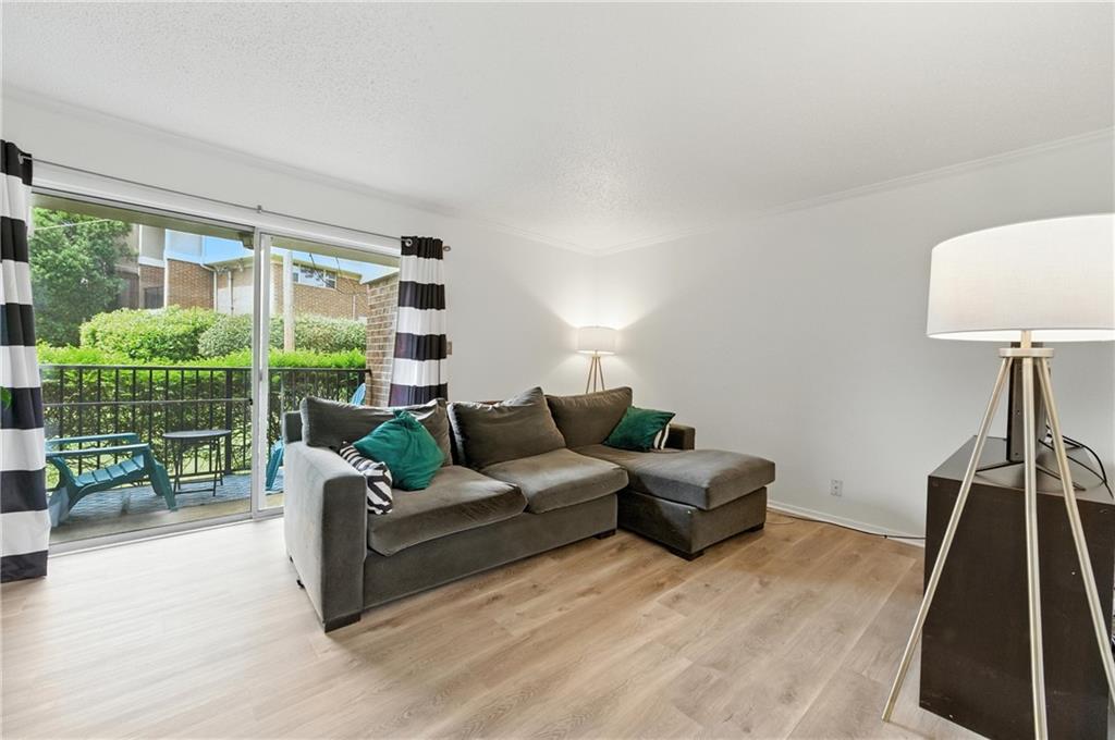 3301 Henderson Mill Road, Unit AA3 Atlanta, GA 30341 - Photo 4 of 32 a living room with furniture and a floor to ceiling window