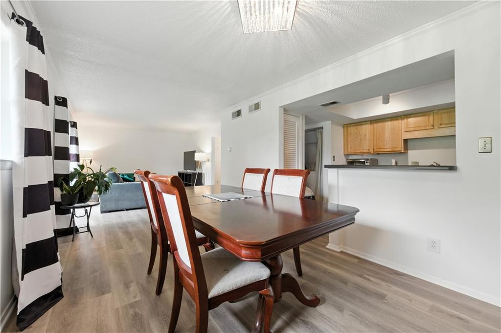 3301 Henderson Mill Road, Unit AA3 Atlanta, GA 30341 - Photo 9 of 32 a view of a dining room with furniture and wooden floor