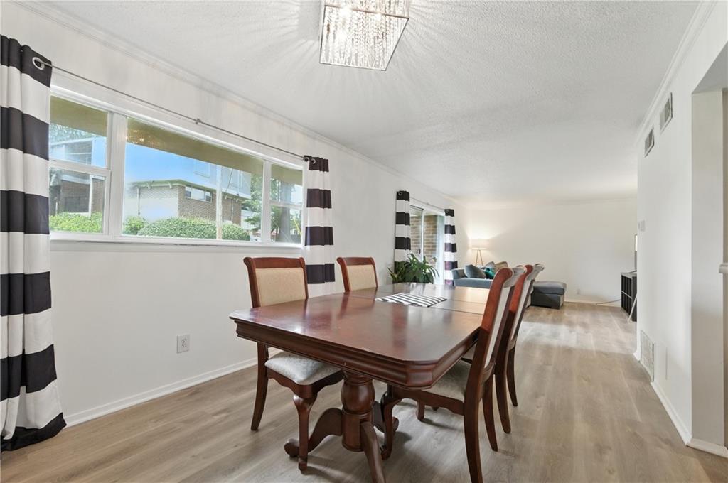 3301 Henderson Mill Road, Unit AA3 Atlanta, GA 30341 - Photo 10 of 32 a view of a dining room with furniture and wooden floor