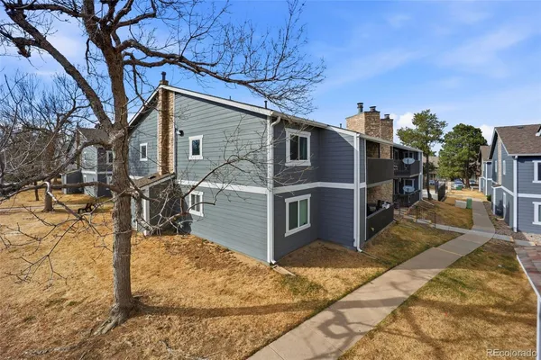 a view of a house with wooden fence