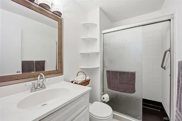 a bathroom with a sink toilet and shower