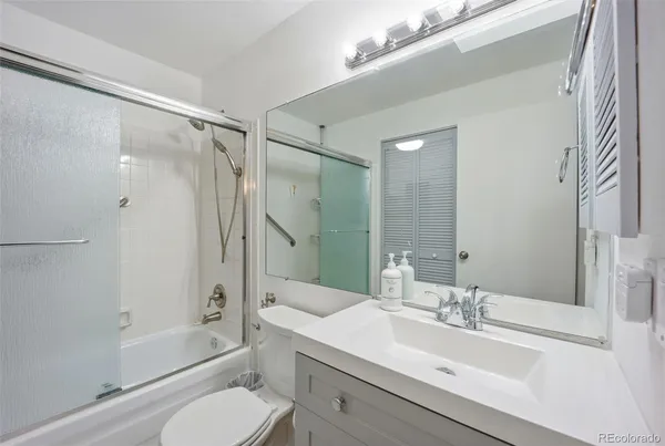 a bathroom with a sink toilet tub and shower