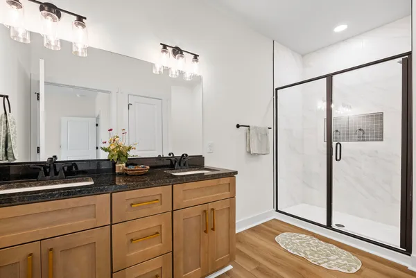 a bathroom with a double vanity sink and mirror