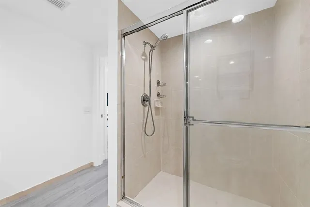 a bathroom with a glass shower door
