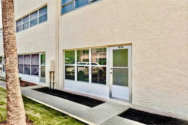 a view of a house with backyard porch and wooden floor