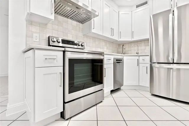 a kitchen with appliances and cabinets