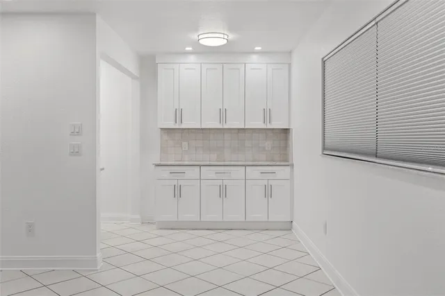 a view of kitchen with white cabinets