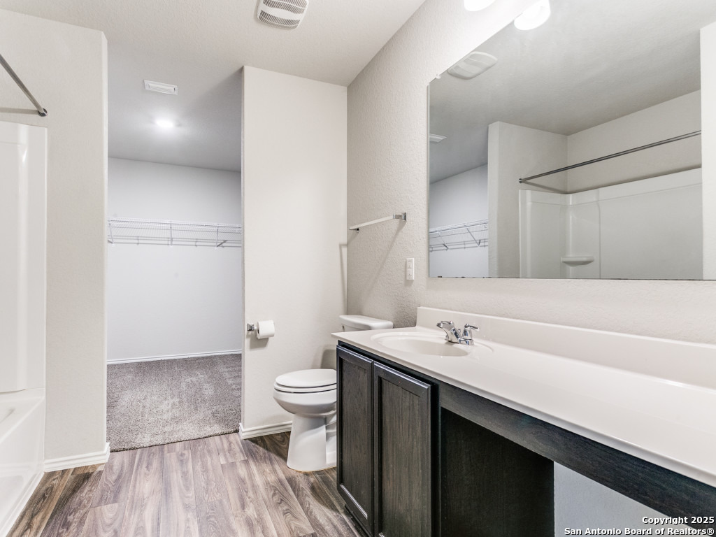 9410 Sandy Rdg Way San Antonio, TX 78239 - Photo 11 of 19 a bathroom with a sink a toilet a shower and a mirror