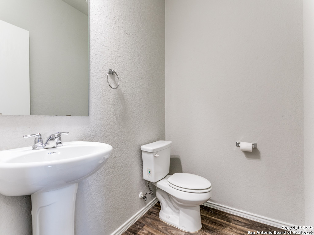 9410 Sandy Rdg Way San Antonio, TX 78239 - Photo 18 of 19 a bathroom with a sink a toilet and mirror