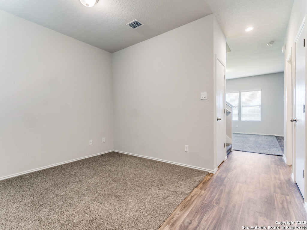 9410 Sandy Rdg Way San Antonio, TX 78239 - Photo 3 of 19 an empty room with wooden floor and windows