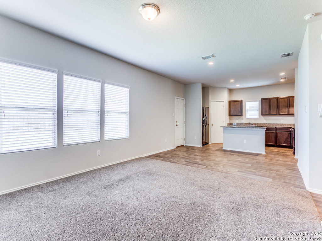 9410 Sandy Rdg Way San Antonio, TX 78239 - Photo 7 of 19 an empty room with a kitchen and window