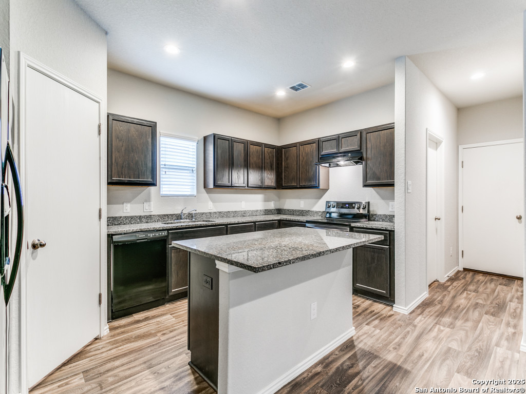 9410 Sandy Rdg Way San Antonio, TX 78239 - Photo 9 of 19 a kitchen with stainless steel appliances granite countertop a stove top oven a sink and a granite counter tops
