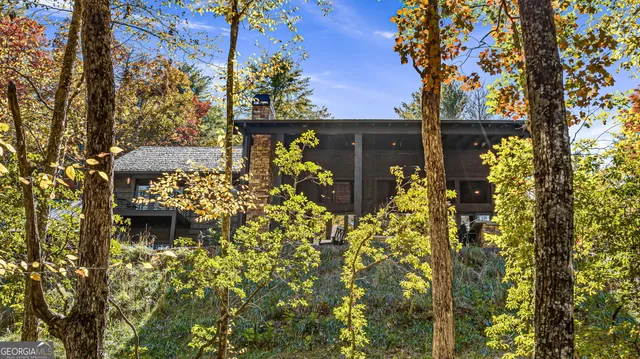 a living room with furniture a fireplace and a floor to ceiling window