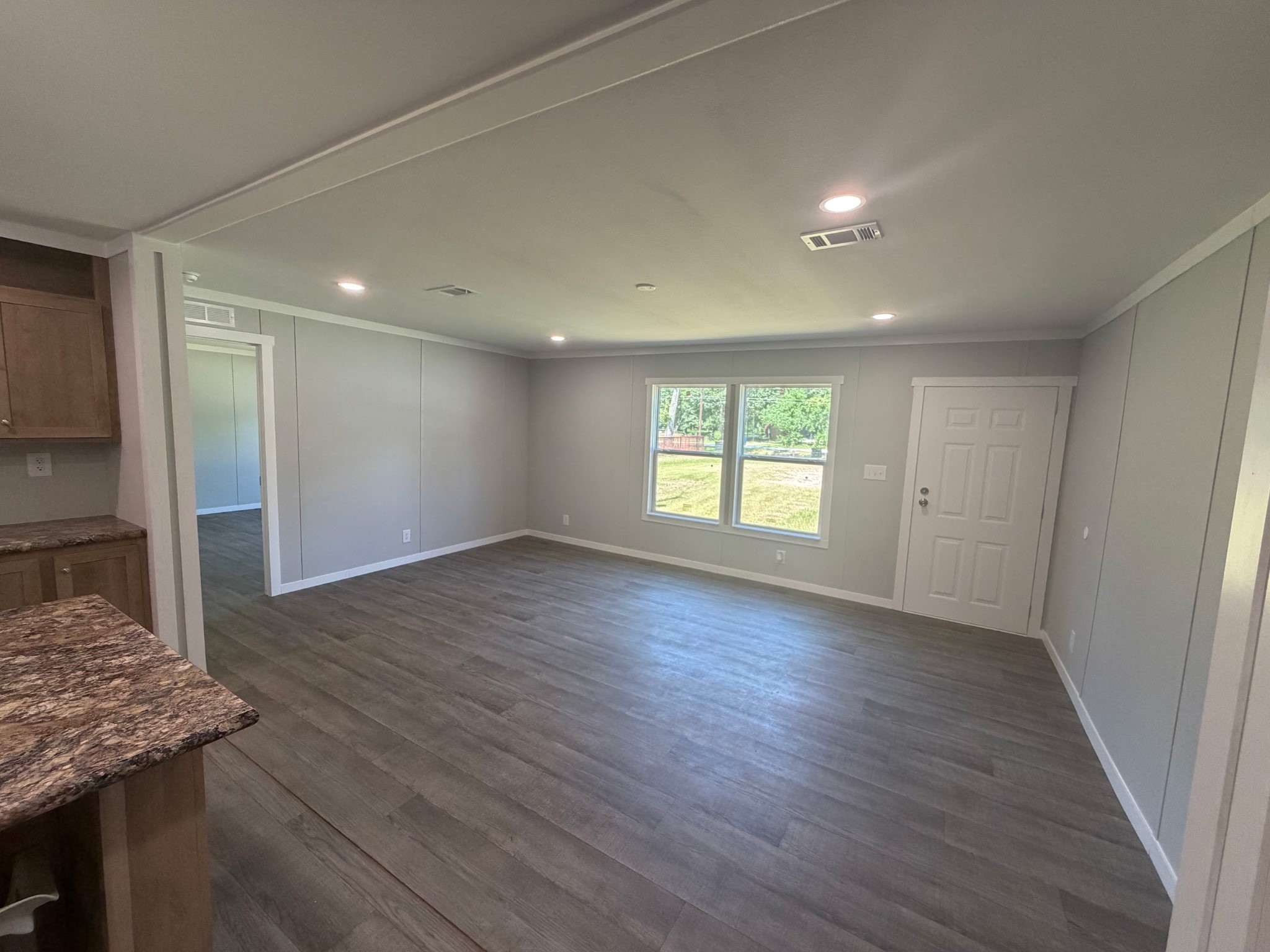15955 Westgate Road Splendora, TX 77372 - Photo 6 of 14 an empty room with wooden floor and windows
