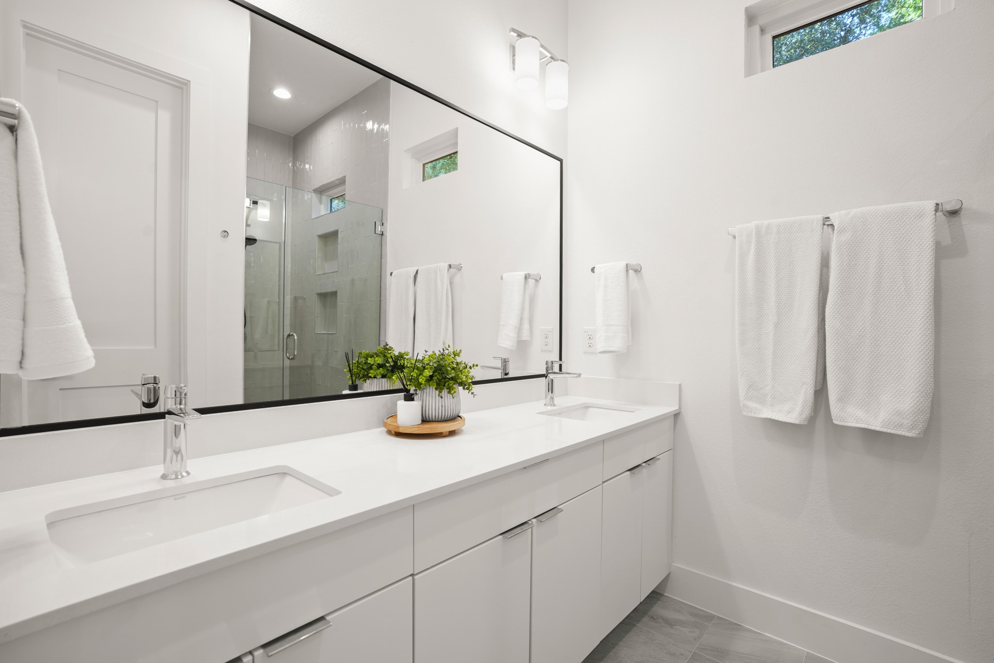 595 Old Mill Road, Unit 206 Cedar Park, TX 78613 - Photo 16 of 39 The primary ensuite bathroom is a refreshing spa-like retreat with refined modern finishes including a dual vanity and custom cabinetry.