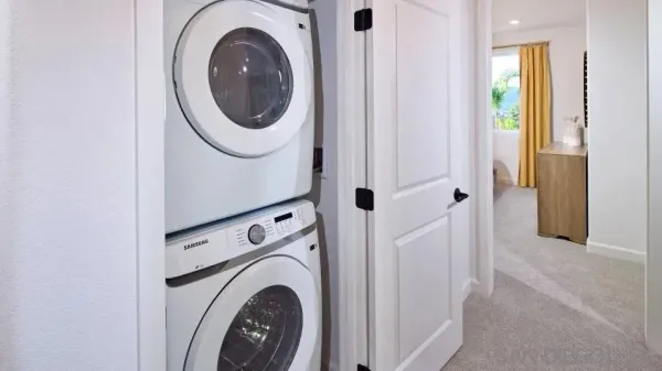 a view of a hallway with washer and dryer