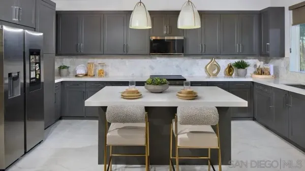 a kitchen with stainless steel appliances a table chairs and a refrigerator