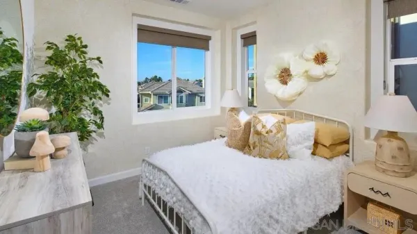 a bedroom with a bed and a potted plant