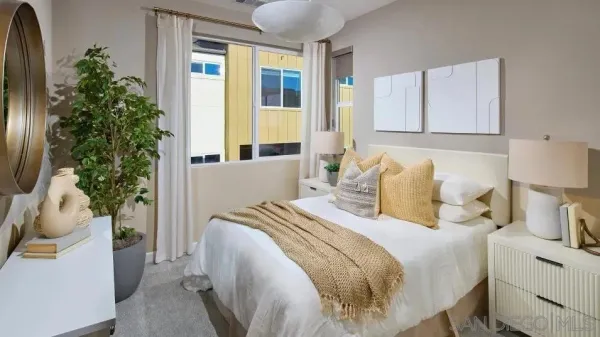 a bed room with a bed and a potted plant